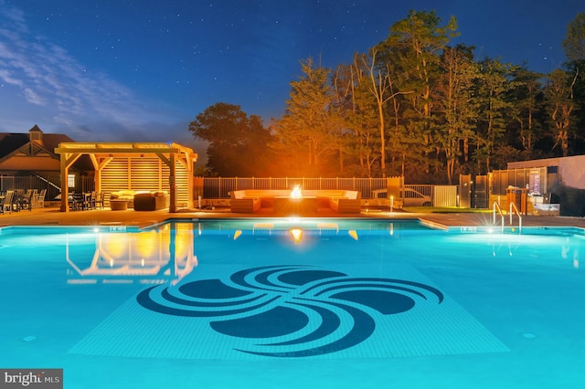 view of swimming pool featuring a pergola, an outdoor living space with a fire pit, and a patio area