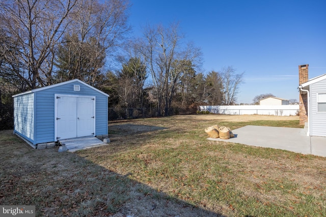 view of yard featuring a shed and a patio