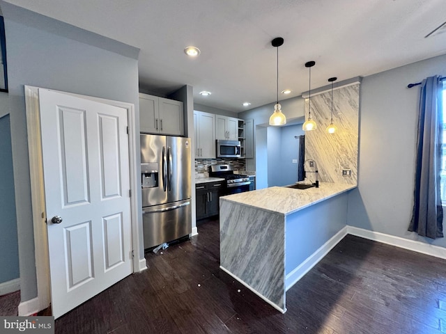 507 N Loudon Ave, Baltimore, MD 21229 - kitchen with stainless steel appliances, open shelves, a peninsula, dark wood-style floors, and tasteful backsplash