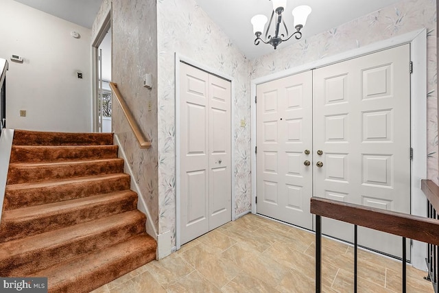 foyer entrance with an inviting chandelier