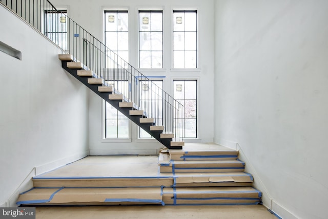 913 Drexel Ln, Bryn Mawr, PA 19010 - stairway featuring a towering ceiling and baseboards