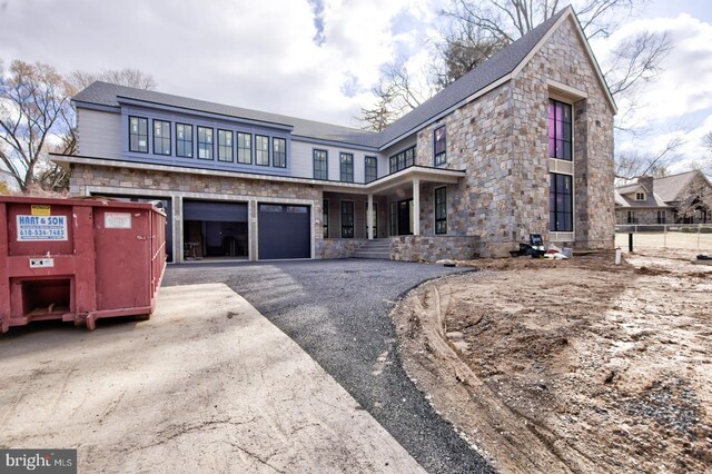 913 Drexel Ln, Bryn Mawr, PA 19010 - view of front of property with stone siding, asphalt driveway, and a garage
