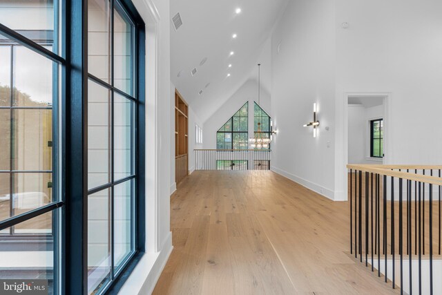 913 Drexel Ln, Bryn Mawr, PA 19010 - corridor featuring high vaulted ceiling, wood finished floors, a chandelier, baseboards, and recessed lighting