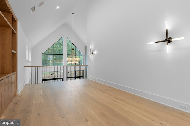 913 Drexel Ln, Bryn Mawr, PA 19010 - additional living space with light wood-type flooring, baseboards, a ceiling fan, a chandelier, and high vaulted ceiling