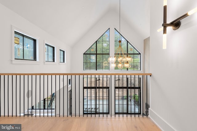 913 Drexel Ln, Bryn Mawr, PA 19010 - bonus room featuring a chandelier, wood finished floors, and high vaulted ceiling