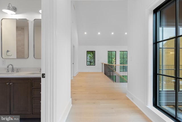 913 Drexel Ln, Bryn Mawr, PA 19010 - corridor with light wood-style flooring, a sink, baseboards, and high vaulted ceiling