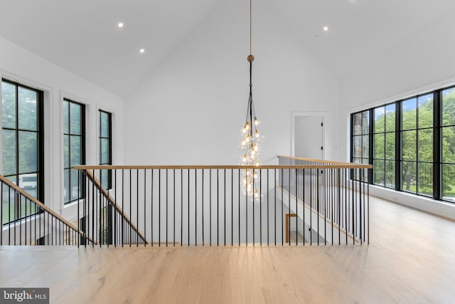 913 Drexel Ln, Bryn Mawr, PA 19010 - hall featuring high vaulted ceiling, a chandelier, wood finished floors, an upstairs landing, and recessed lighting