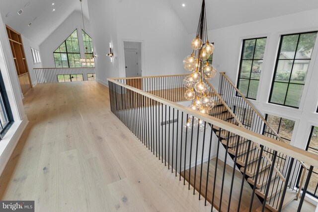 913 Drexel Ln, Bryn Mawr, PA 19010 - corridor with a chandelier, high vaulted ceiling, wood finished floors, an upstairs landing, and recessed lighting