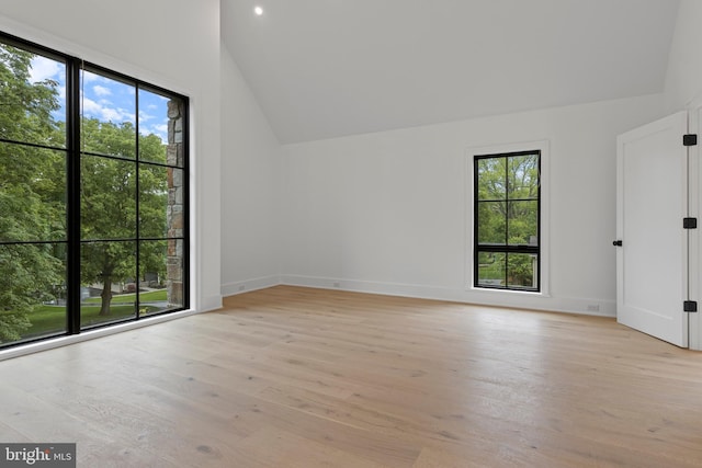 913 Drexel Ln, Bryn Mawr, PA 19010 - empty room featuring healthy amount of natural light, lofted ceiling, light wood finished floors, baseboards, and recessed lighting