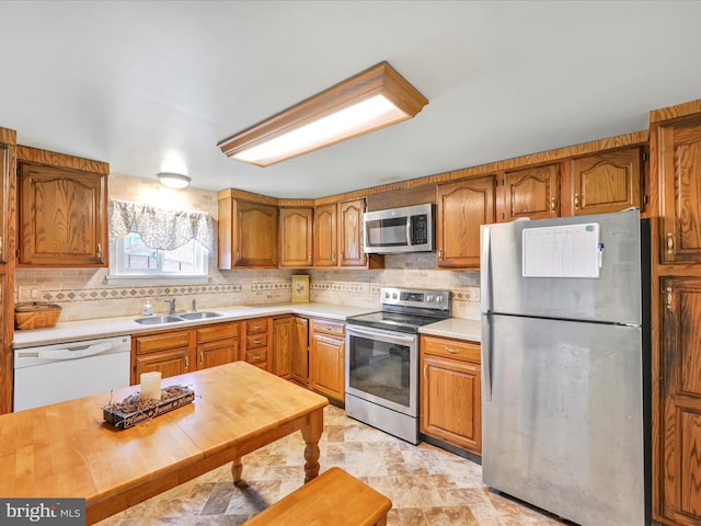 kitchen featuring sink, appliances with stainless steel finishes, and tasteful backsplash