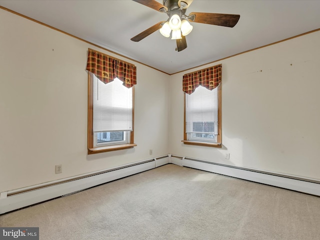 carpeted empty room featuring ceiling fan, crown molding, and a baseboard heating unit