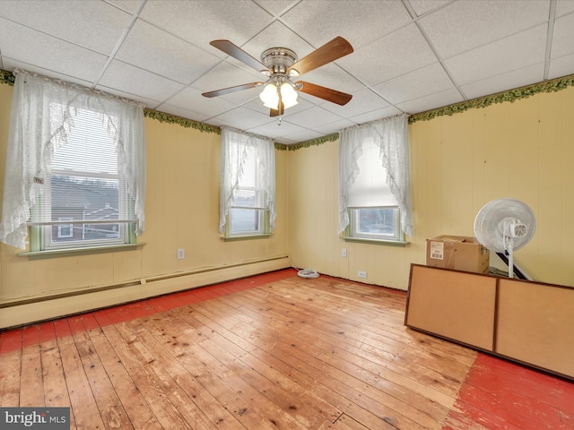 interior space featuring a paneled ceiling, ceiling fan, hardwood / wood-style flooring, and a baseboard radiator