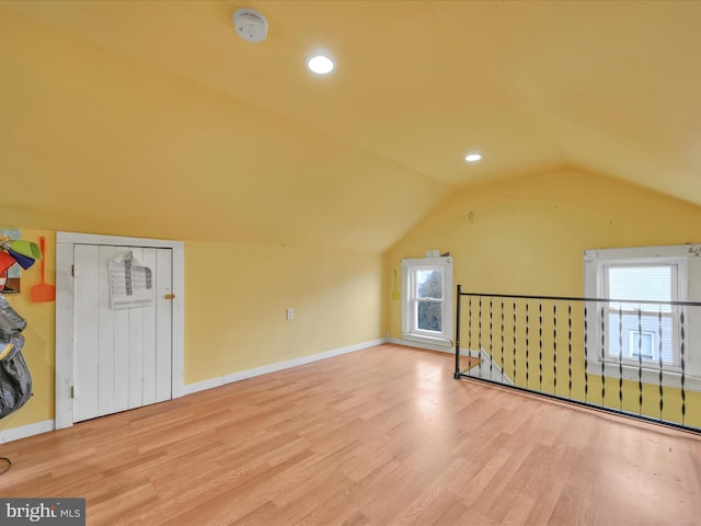 bonus room featuring hardwood / wood-style flooring, plenty of natural light, and lofted ceiling