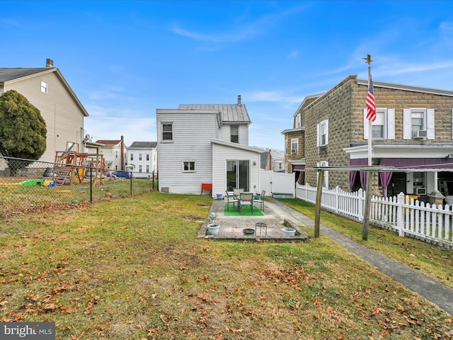 back of property with a lawn, a patio area, and cooling unit