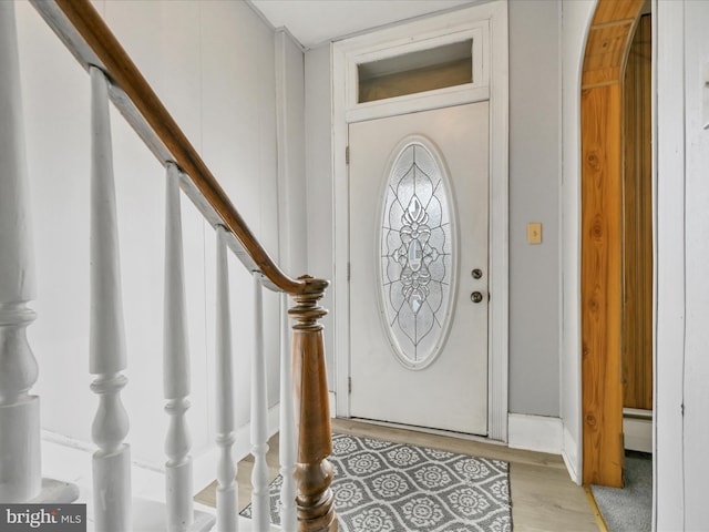 entrance foyer featuring a baseboard heating unit and light hardwood / wood-style flooring