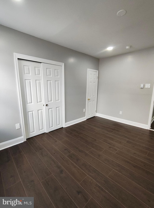 unfurnished bedroom featuring dark wood-type flooring