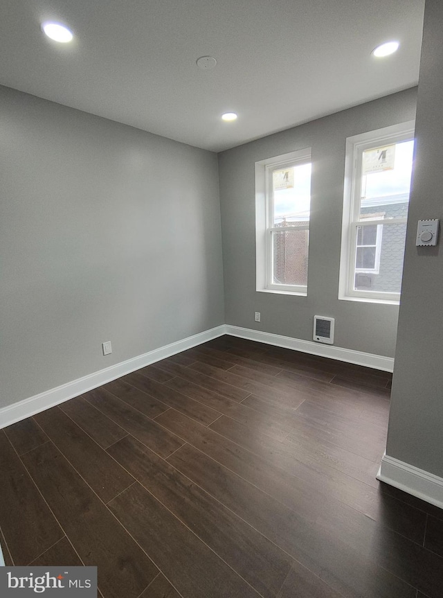 spare room with dark hardwood / wood-style floors