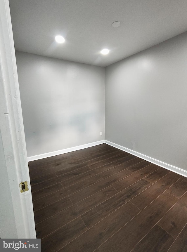 spare room with dark wood-type flooring