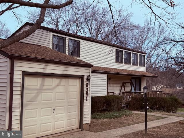 view of front of house featuring roof with shingles and an attached garage