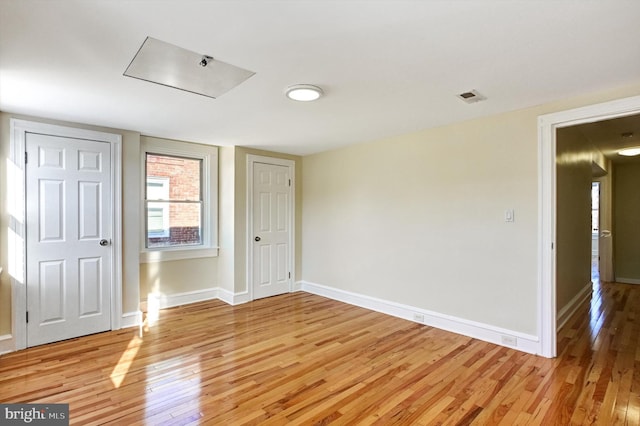 spare room featuring light hardwood / wood-style floors