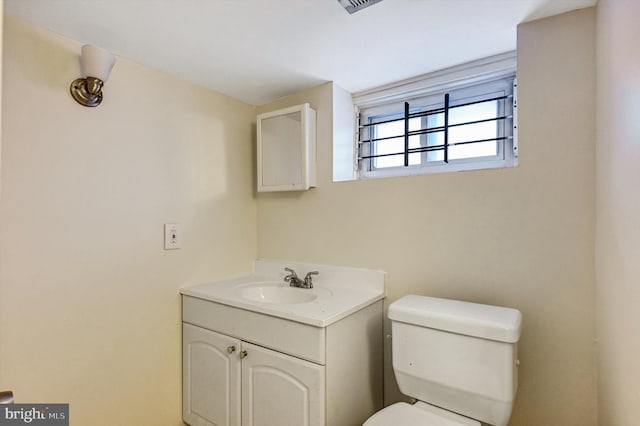 bathroom featuring vanity and toilet