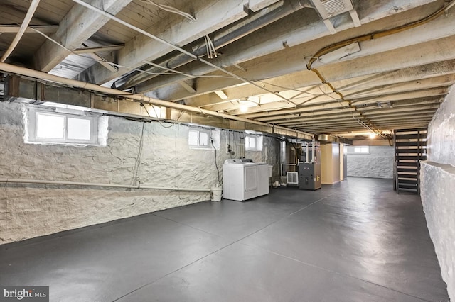 basement with washer / clothes dryer and heating unit