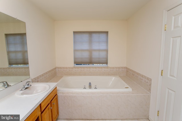 bathroom featuring vanity and tiled bath