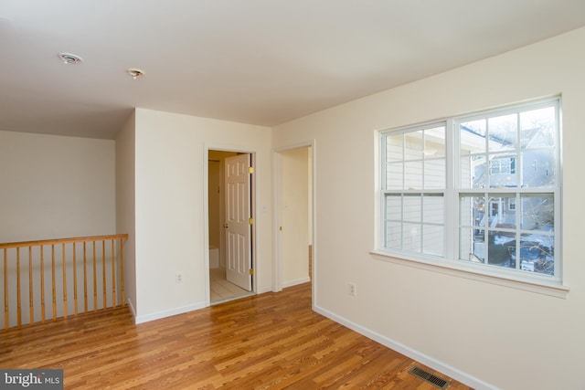 spare room with light hardwood / wood-style floors