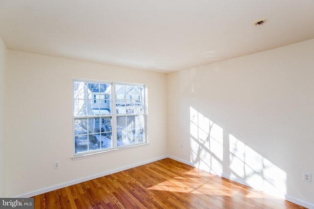 unfurnished room featuring hardwood / wood-style floors