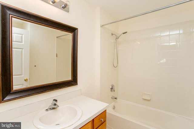 bathroom featuring vanity and tiled shower / bath