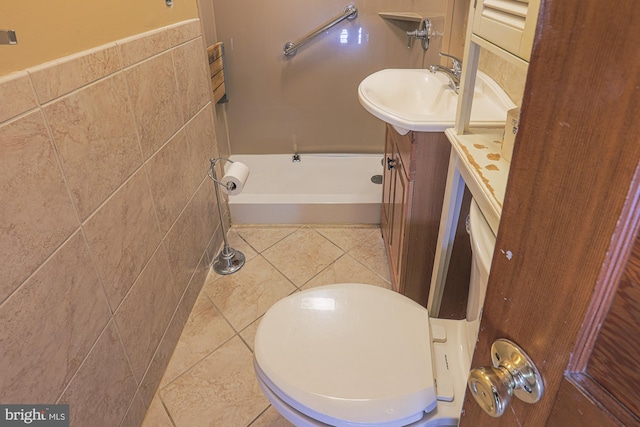 bathroom featuring tile walls, tile patterned flooring, a shower, and vanity