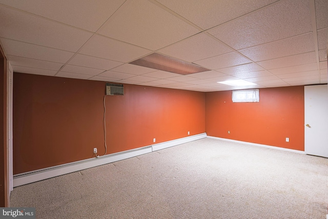 basement with baseboard heating and carpet