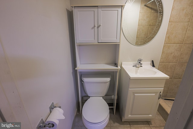 bathroom with tile patterned floors, vanity, and toilet