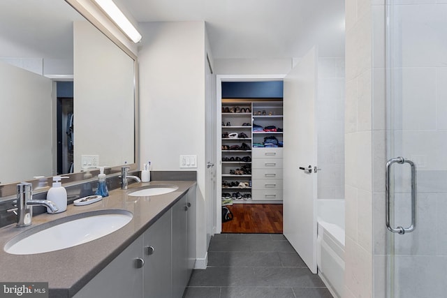 bathroom with tile patterned floors, separate shower and tub, and vanity