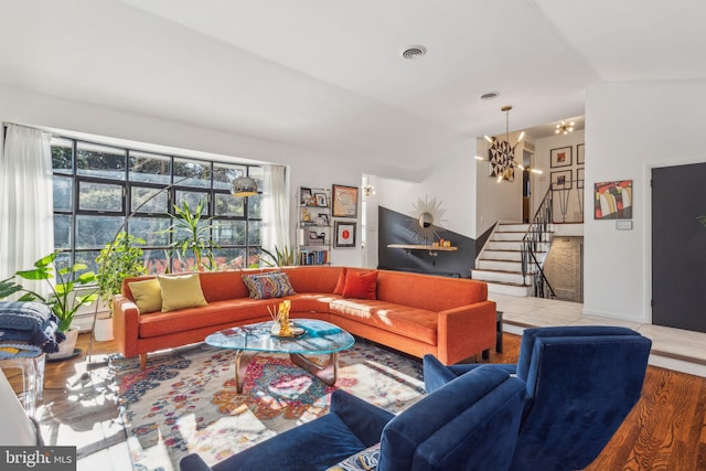 living room featuring a chandelier and vaulted ceiling