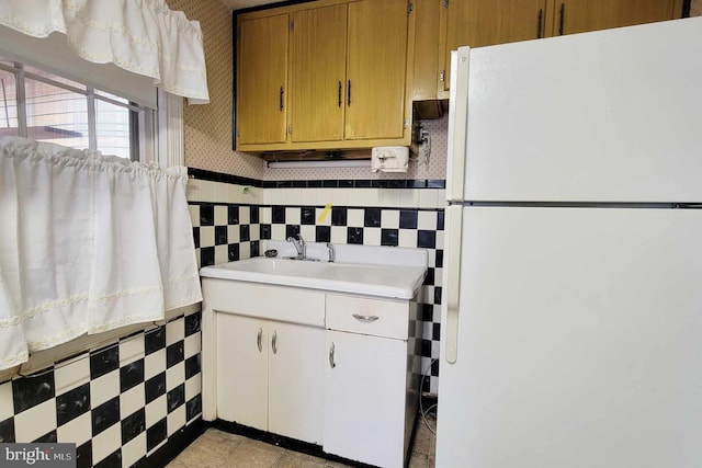 kitchen featuring white fridge and sink