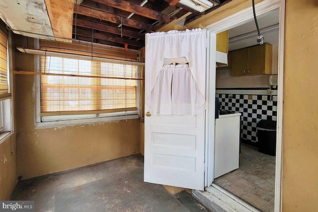 bathroom featuring washer / clothes dryer and concrete flooring