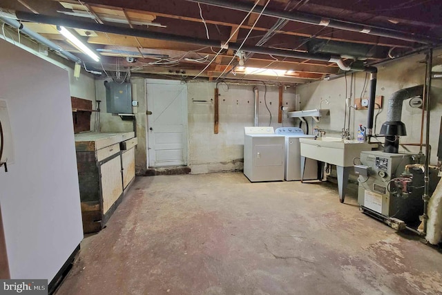 basement with washer and dryer, electric panel, and sink