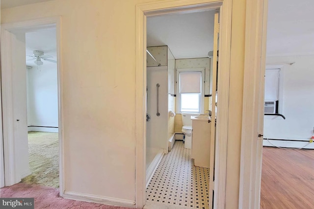 corridor featuring light colored carpet, cooling unit, and a baseboard heating unit