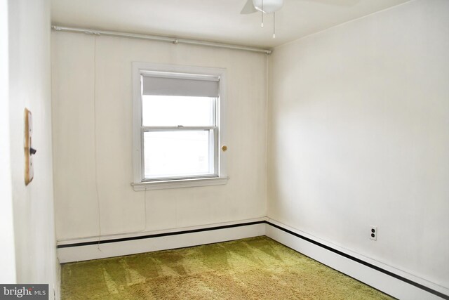 unfurnished room with carpet, ceiling fan, and a baseboard radiator