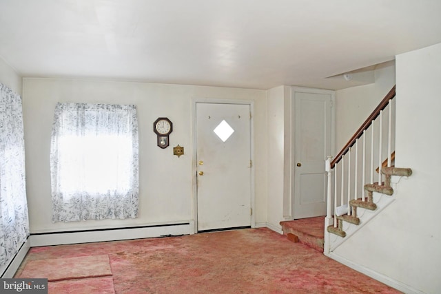 entryway featuring light colored carpet and a baseboard heating unit