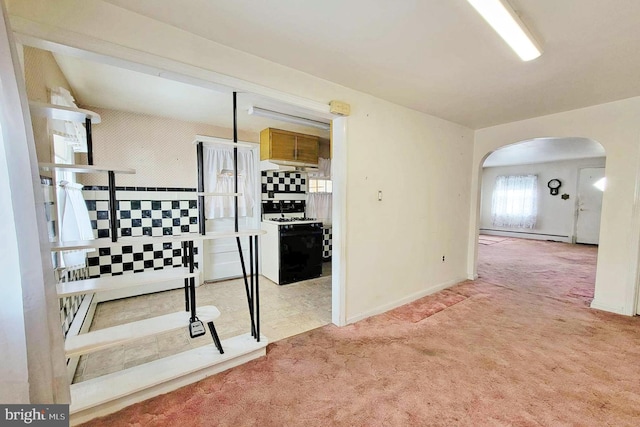 interior space with light colored carpet and a baseboard heating unit