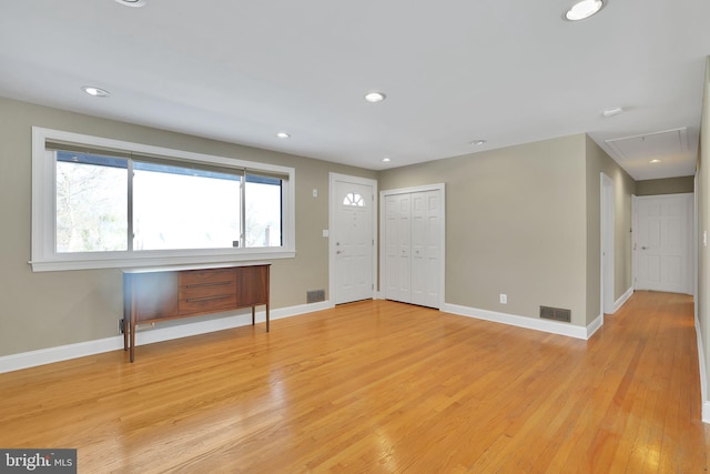 foyer entrance with light hardwood / wood-style floors