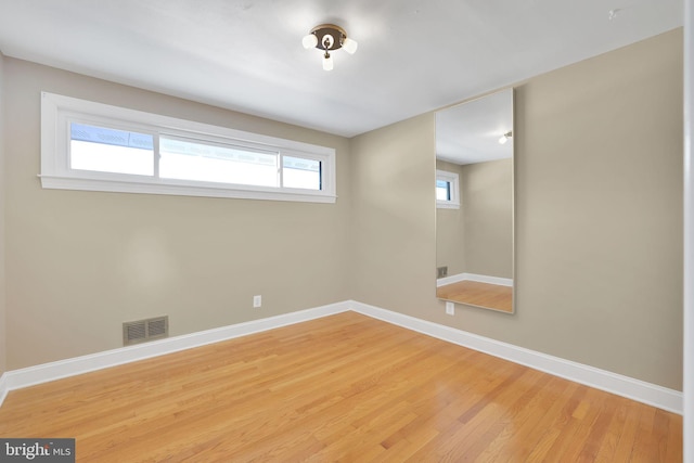 unfurnished room featuring hardwood / wood-style flooring