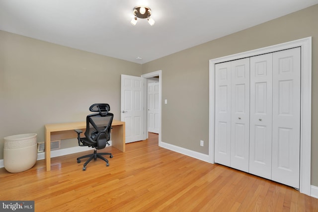 home office with hardwood / wood-style flooring