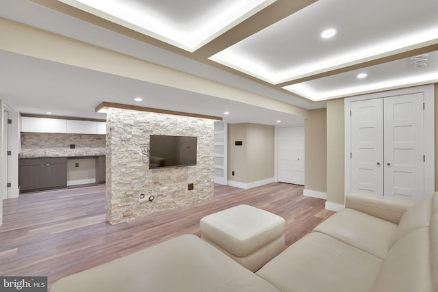 living room with light hardwood / wood-style floors and built in features