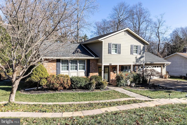 tri-level home with a garage and a front lawn