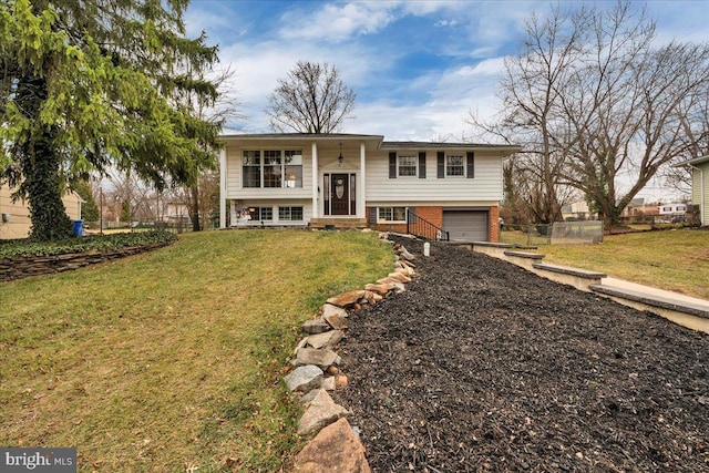 raised ranch featuring a front lawn and a garage