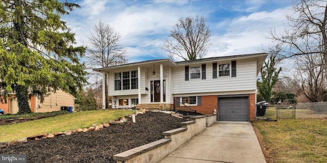 bi-level home with a front lawn and a garage