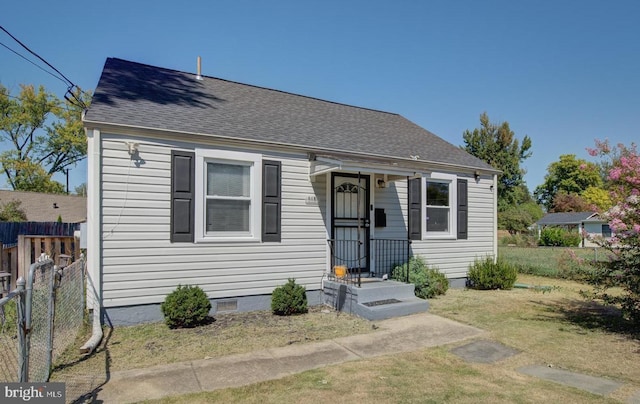 bungalow-style home featuring a front yard